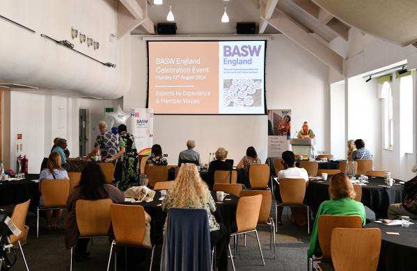 People watching a speaker at BASW England's Celebration Event