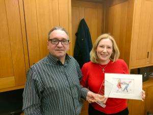 2021 12 16 john mcgowan emma lewell buck SWU General Secretary John McGowan presents Emma Lewell-Buck MP with the SWU Ambassador Award and a personalized "Clare in the Community" cartoon on 15 December 2021 in her Westminster office.
