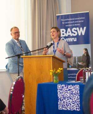 Kathryn Lawrence (BASW Cymru National Standing Committee member) addressing conference to introduce a powerful film with Leah (Expert by Experience)