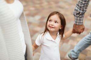 child holding parents hands